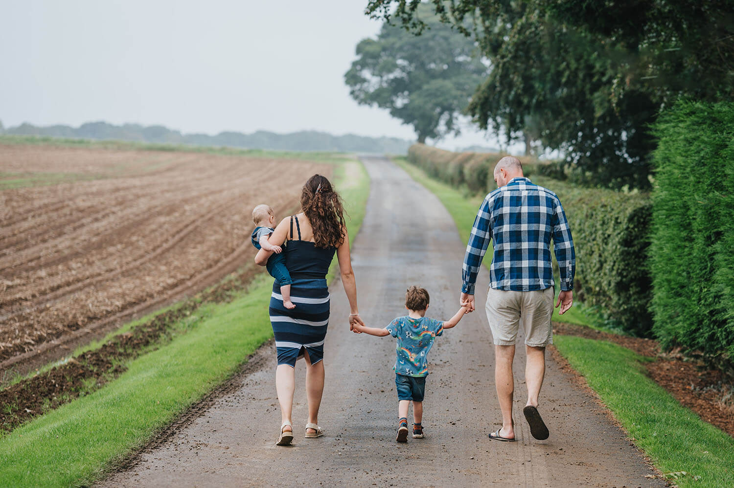 Kathryn and family walking on the farm backs away from camera